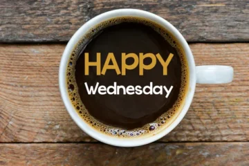 A person laughing at their desk on Wednesday, surrounded by funny quotes and coffee mugs, capturing the humor of midweek workday.